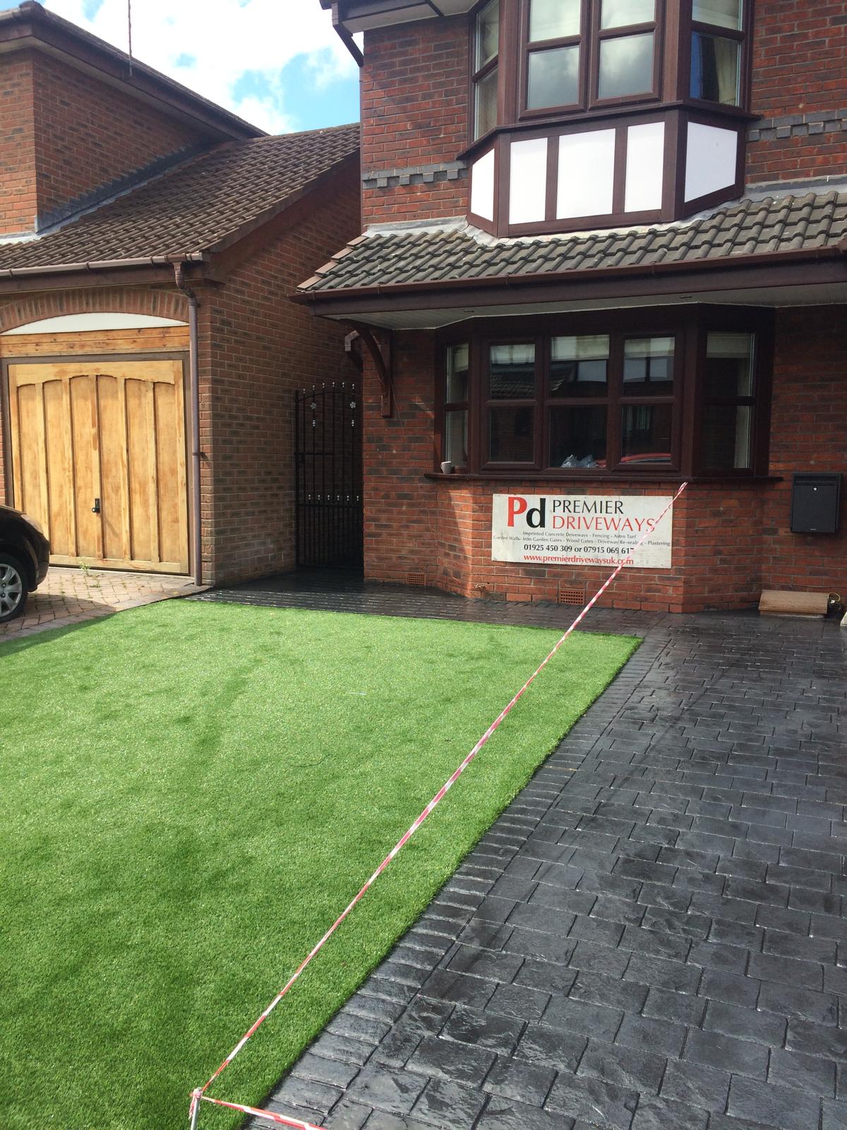 Charcoal imprinted concrete driveway with artificial grass, front garden makeover, Warrington